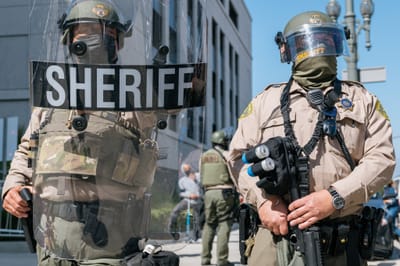 LASD deputies wearing riot gear in a skirmish line outside the Hall of Justice June 2021.